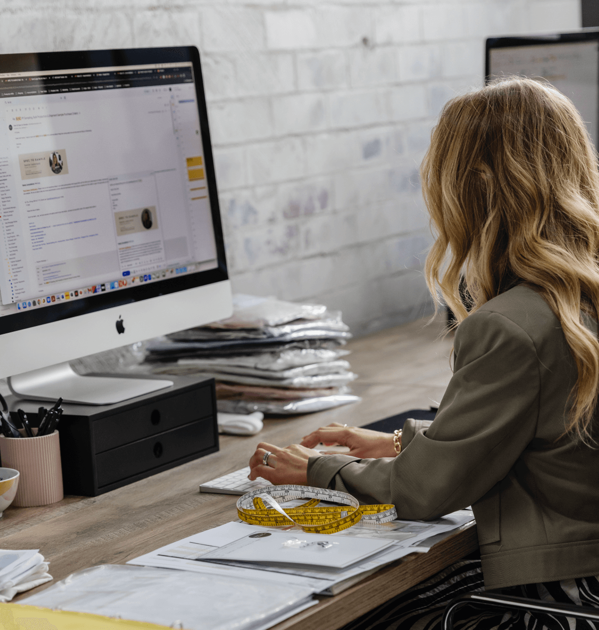 Australian Fashion designer emailing manufacturers and suppliers to discuss working together