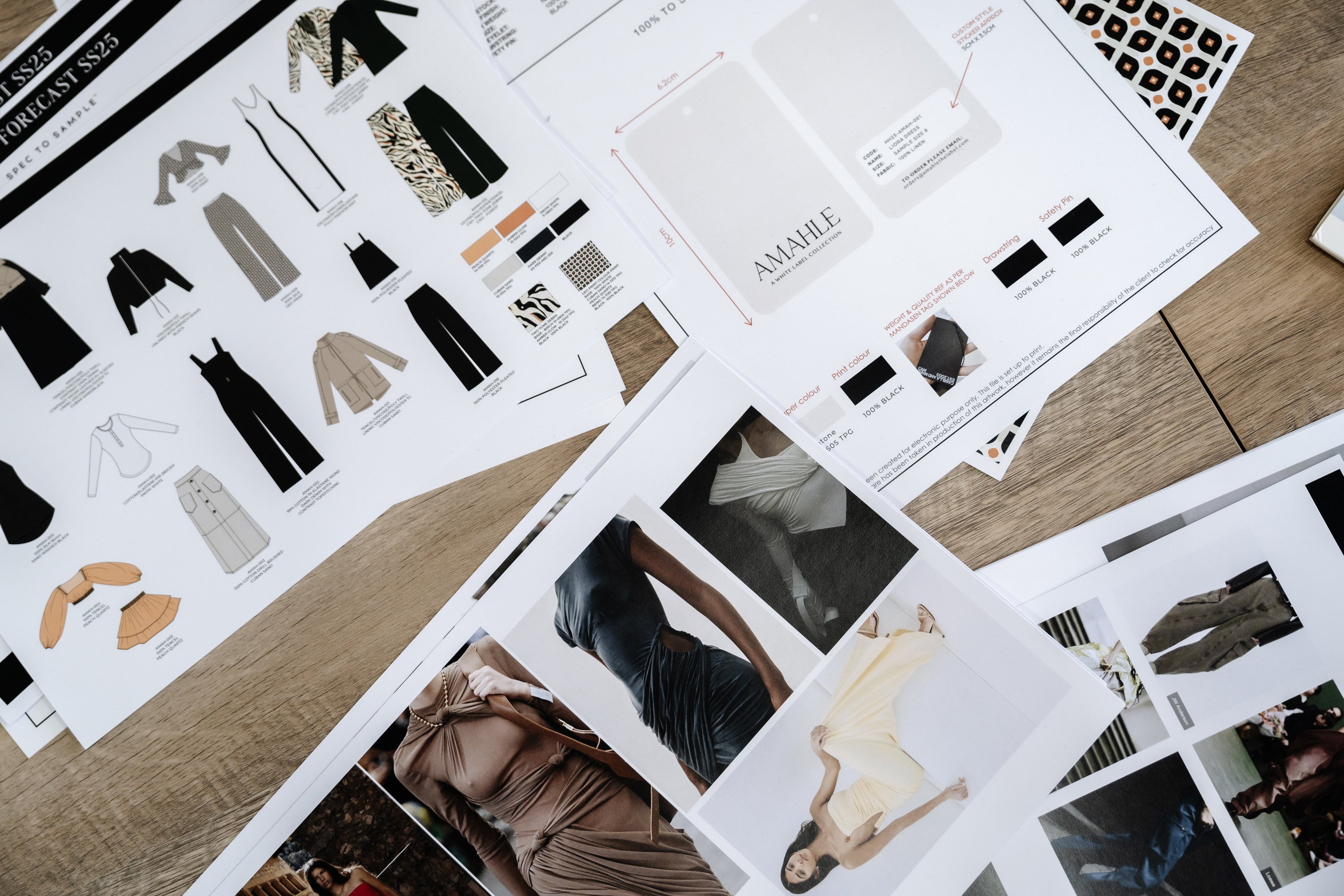 Flatlay of documents and trademark files for protecting fashion brand IP.